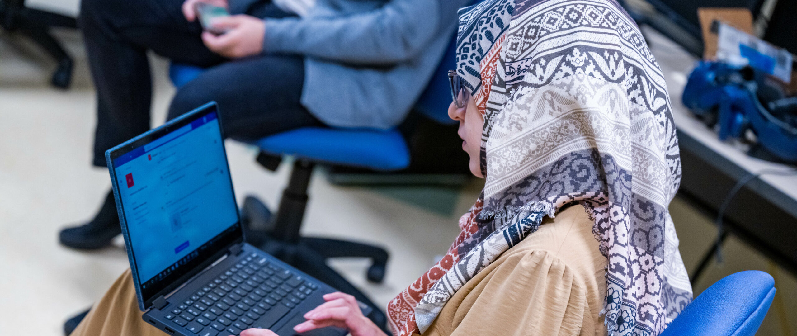 student working on a laptop in a computer lab