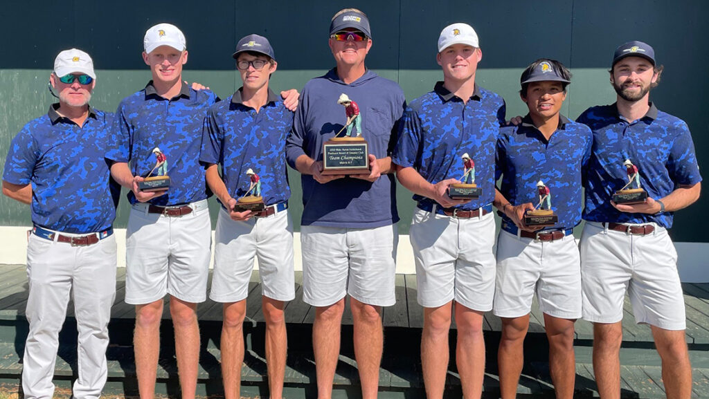 Men's golf team carries their trophies from the Wake Forest Invitational.