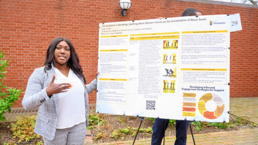 Graduate student Kayla Baker presents her research at Research and Creativity Showcase.