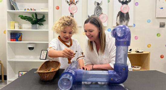 Dr. Nicole Perry, alumna of Human Development and Family Studies, plays with her son in her lab.