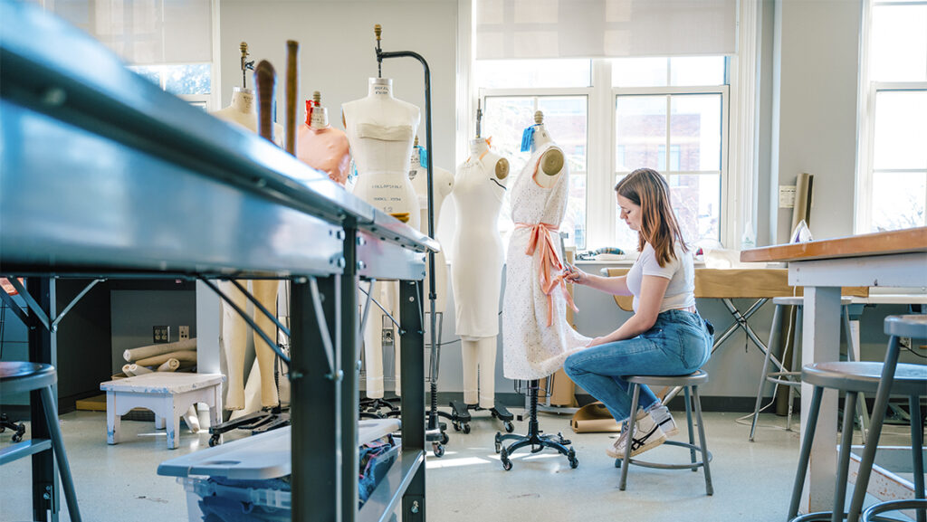 Lisa Woolfall working with dress on form.