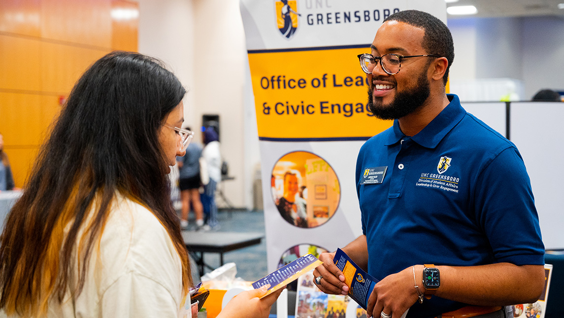 A SOAR volunteer speaks with a student.