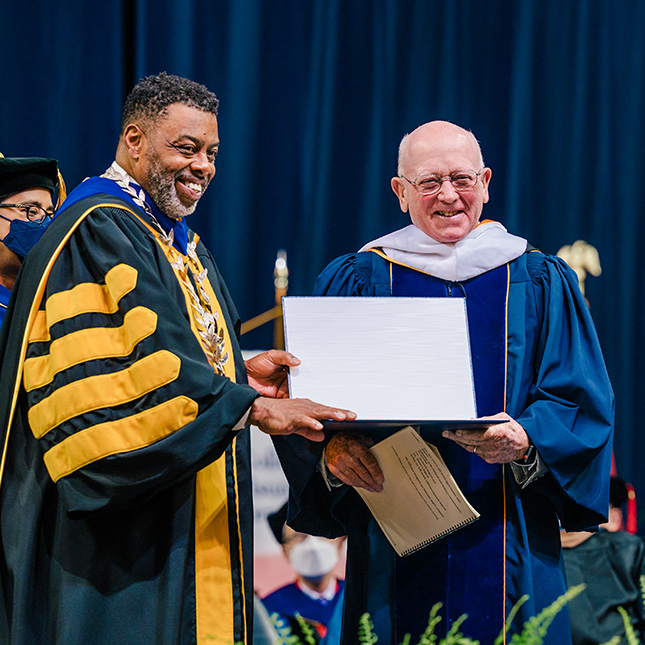 Chancellor Gilliam gives honorary degree to David Sprinkle.