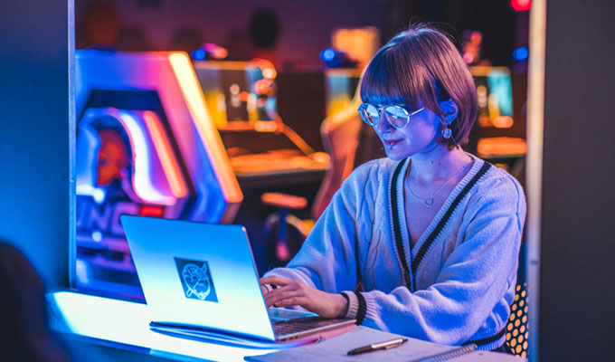 Sophia Rosenberg playing games in the esports arena and also doing research.