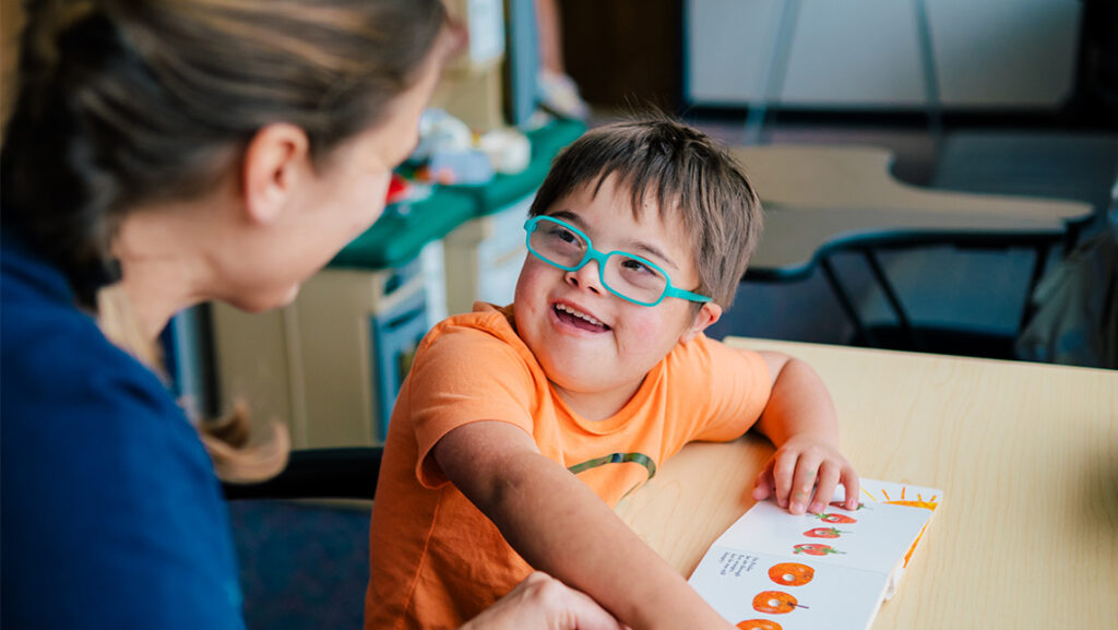 A child smiles at an adult