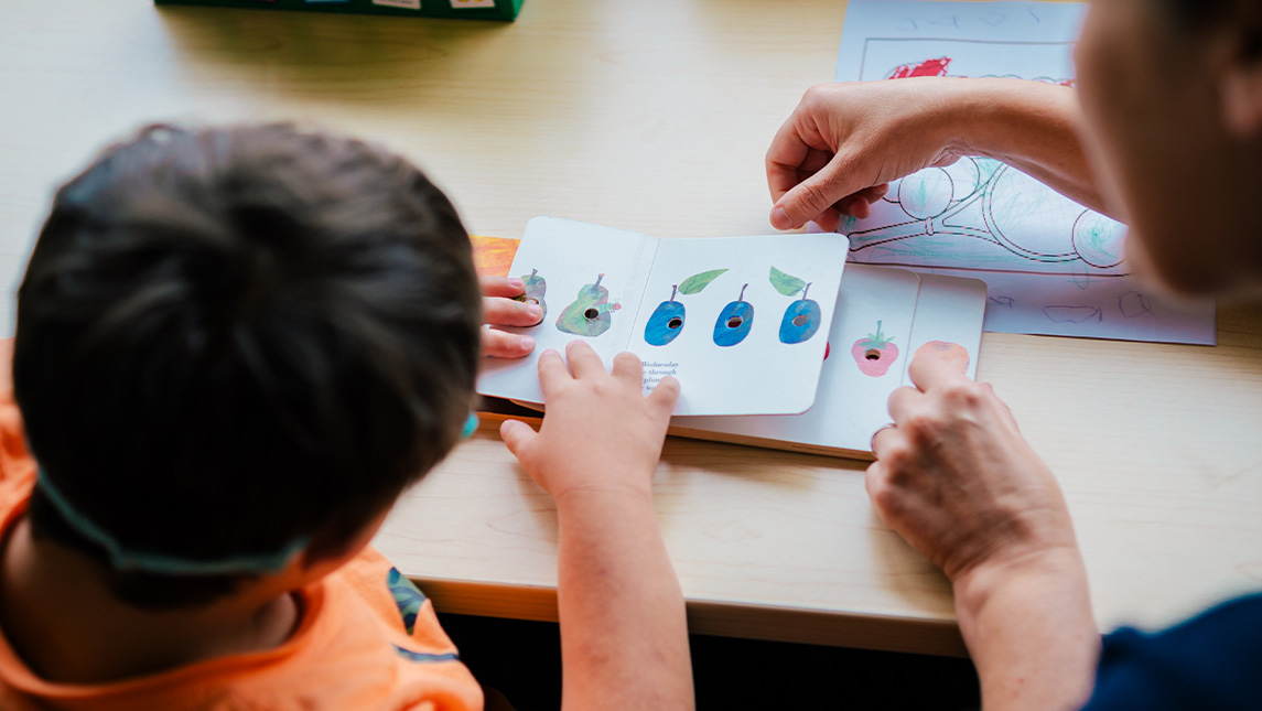 Image of child and book.
