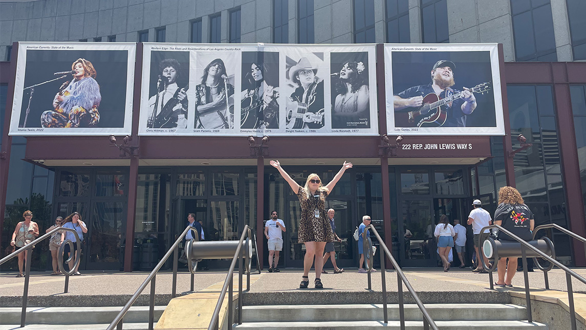 UNCG graduate student Tori Hinslaw stands in front of the Country Music Hall of Fame