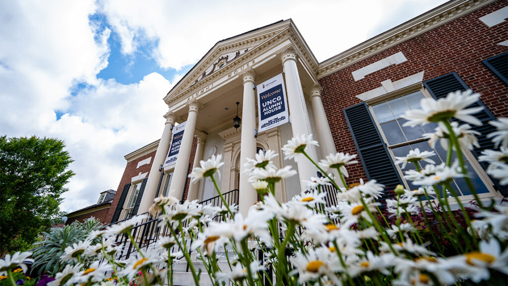 Daisies grow outside the UNCG Alumni House.