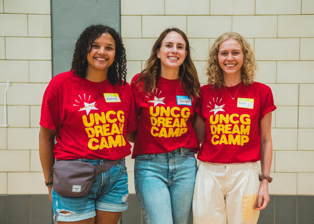 Three female counselors wearing Dream Camp shirts.