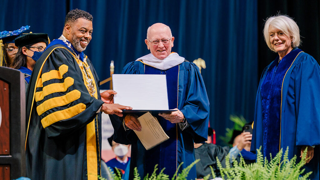 UNCG Chancellor Gilliam gives David Sprinkle an honorary degree onstage.