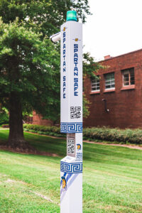 A stanchion on UNCG campus with a QR code.