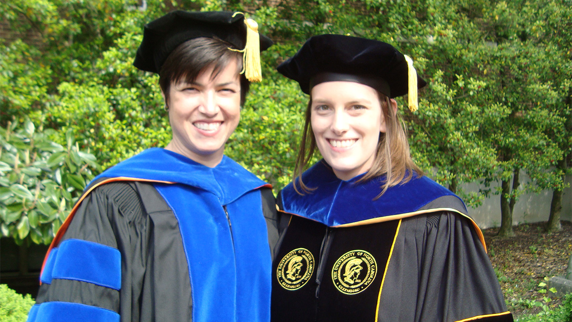 UNCG doctoral student Beatrice Kuhlmann in her cap and gown with her mentor Dayna Touron.