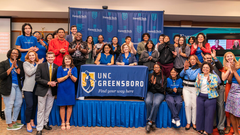 UNCG Provost Debbie Storrs signs an MOU with Forsyth Tech.