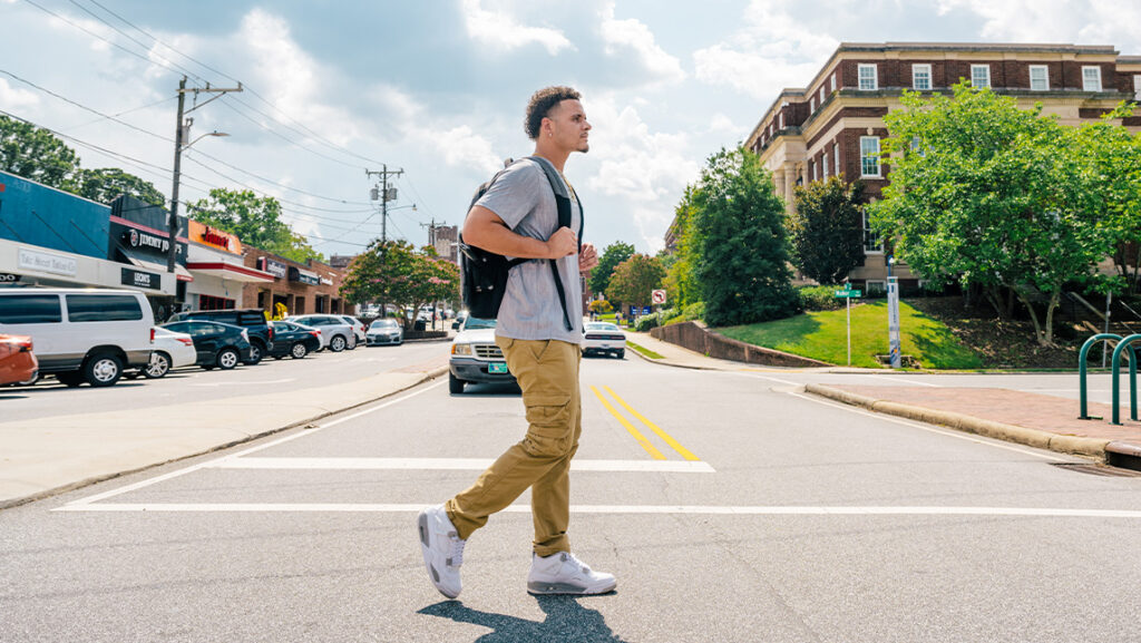 UNCG student walks across Tate St.