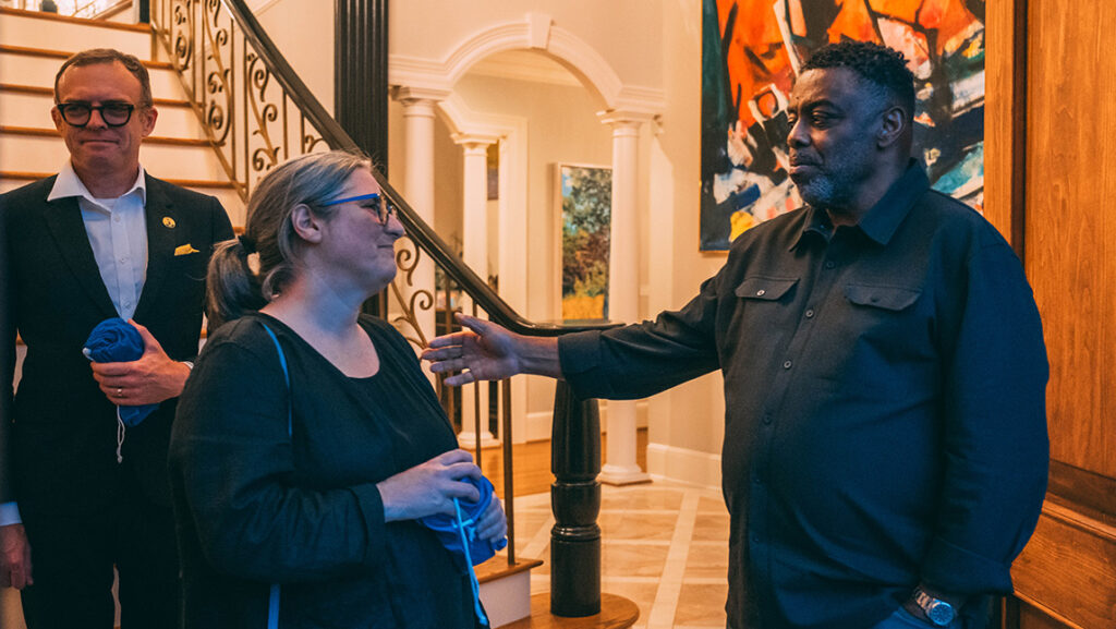 UNCG Chancellor Gilliam welcomes graduate school dean Greg Bell and graduate studies director Sarah Daynes to his residence.