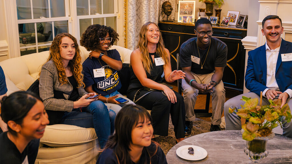 UNCG students sit on couches playing trivia.