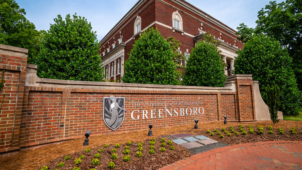 The sign for UNCG when arriving on campus.