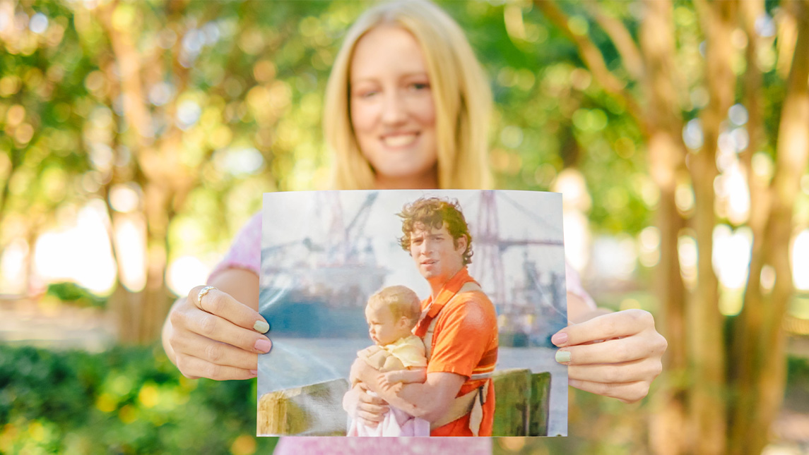 Grace Holcomb holds a photo of herself as a baby on 