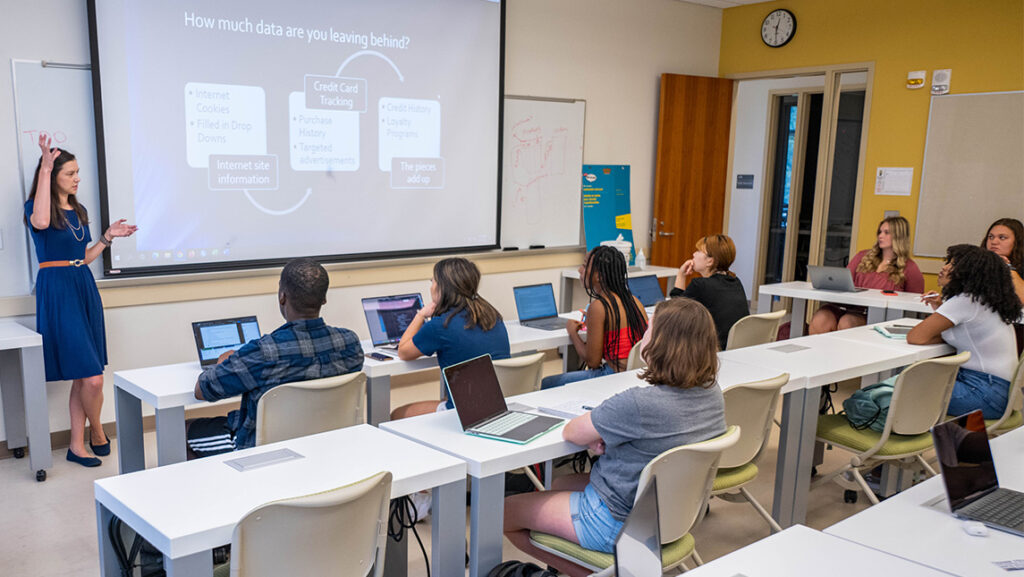 UNCG Lecturer Lisa Barron at the front of a classroom teaching students.