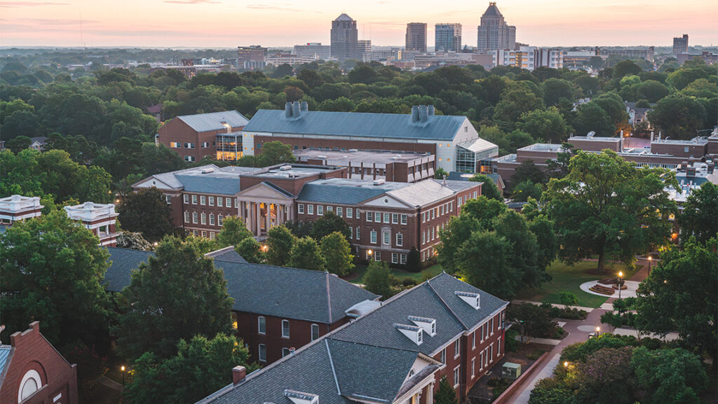 Sun rises over Greensboro and UNCG skyline.