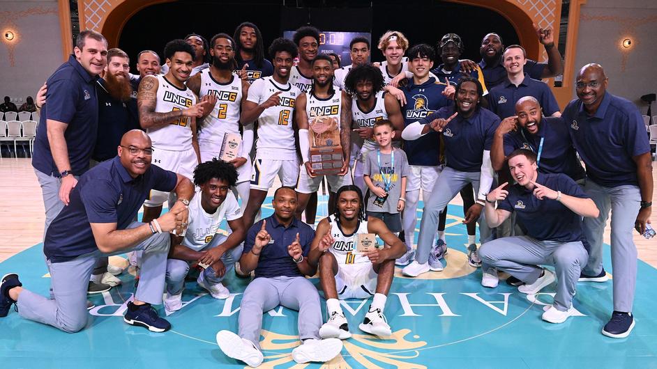 UNCG Men's Basketball team poses in photo