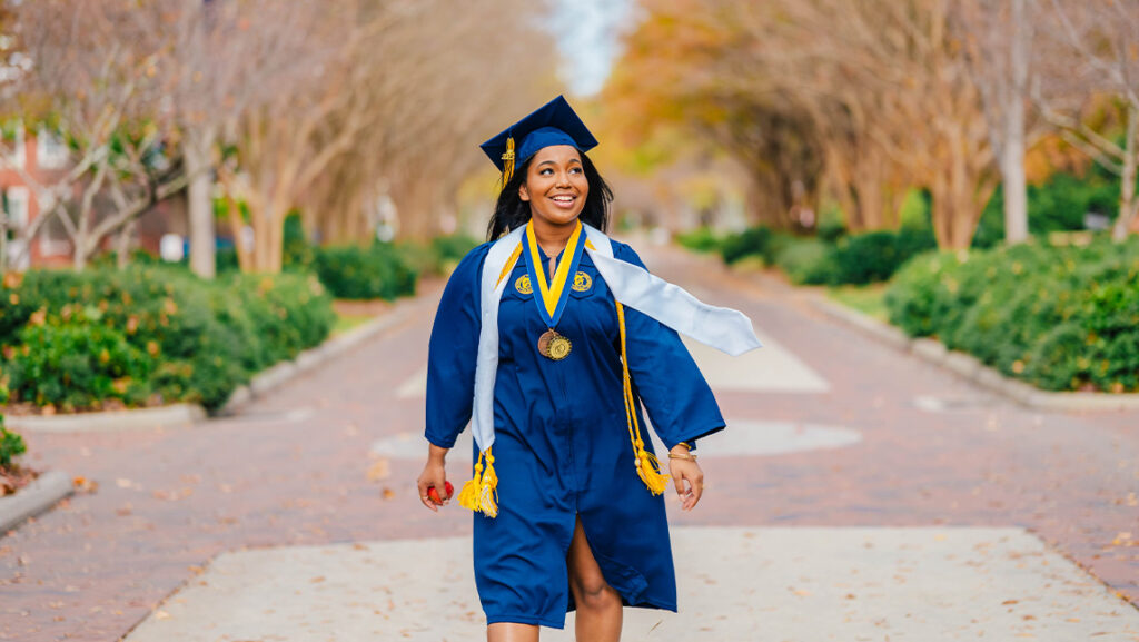 Kemiah Williams walks on UNCG's College Avenue.