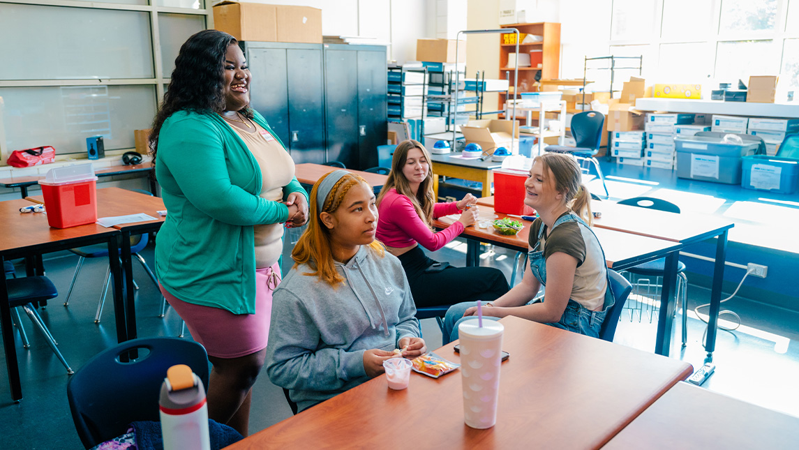 UNCG student Ai'Yonna Williams works with students at The Middle College at UNCG