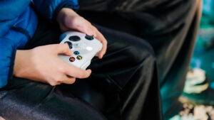Close-up on a game controller in a child's hands.