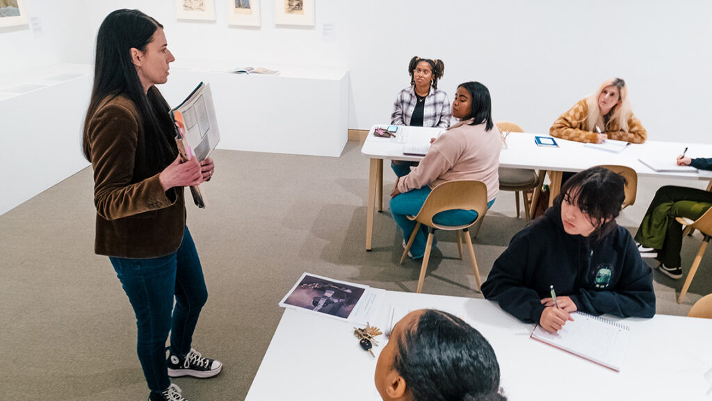 Dr. Heather Holian speaks to a class of UNCG students in the Weatherspoon Art Museum.