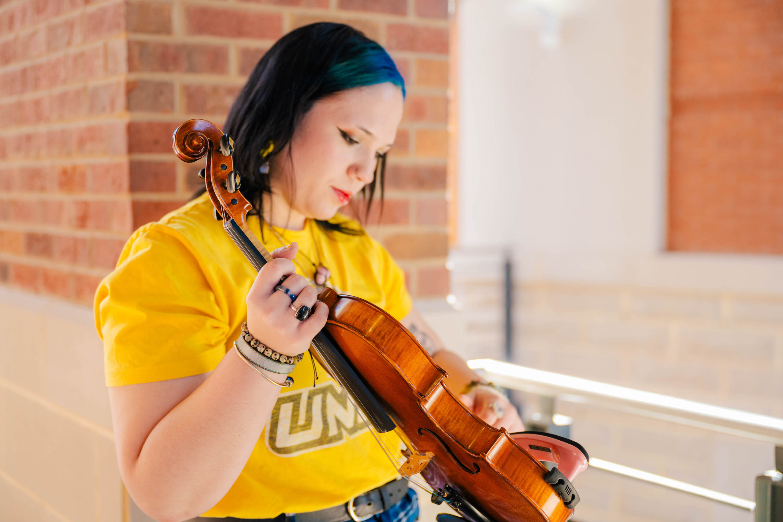 UNCG student Elena Cousin holds a violin