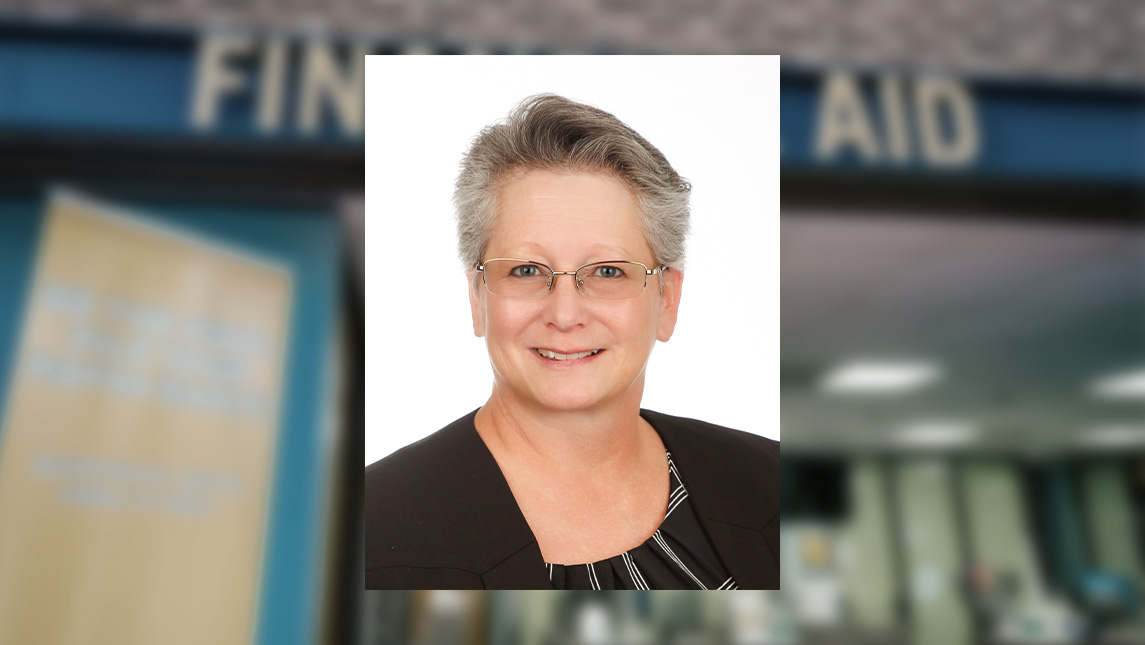 Headshot of Dr. Dawn Herrod with UNCG financial aid office in the background.