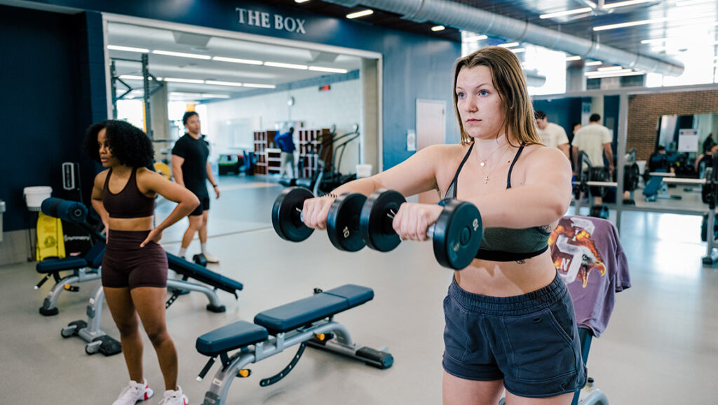 People work out with weights at the UNCG Kaplan Center.