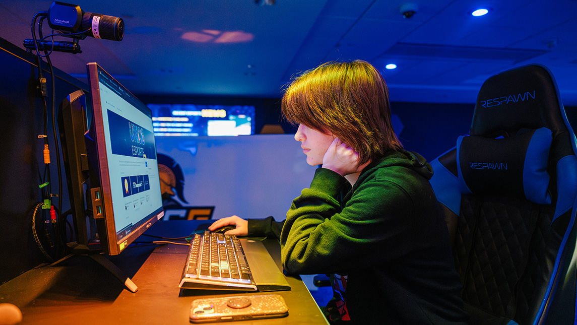 A student uses a computer in the esports arena.
