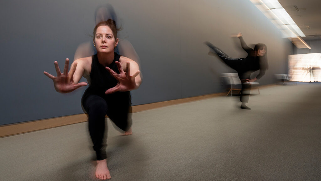 UNCG dance students Liz Anderson and Tiffany Moss Hale dance in the Weatherspoon hallway.