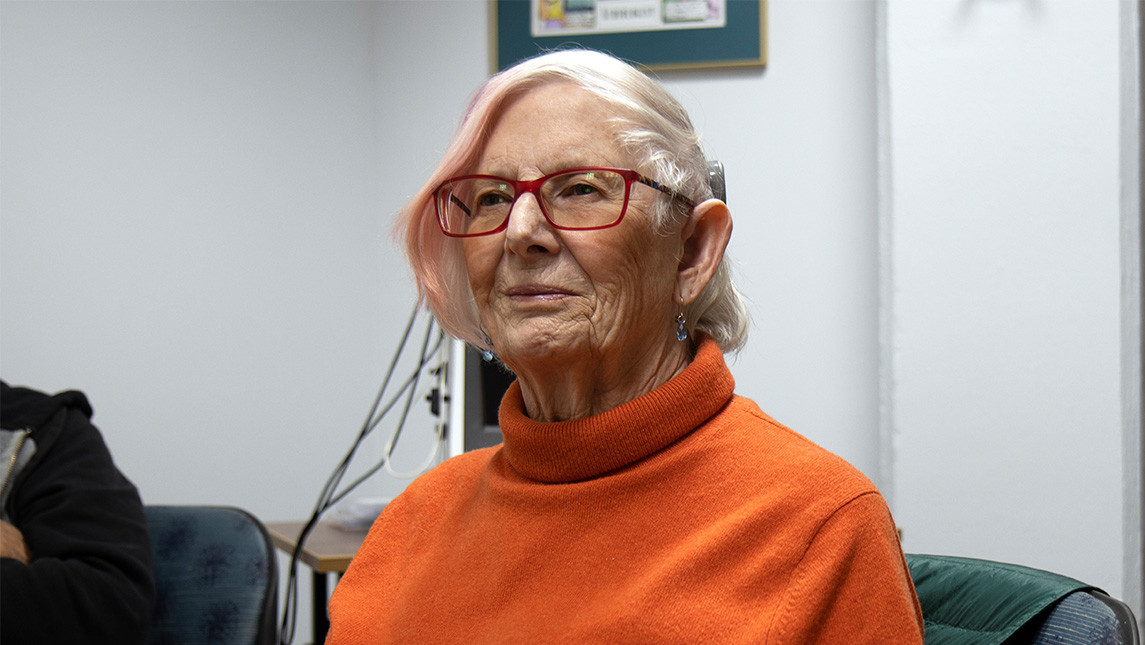 Retired UNCG Professor Elizabeth Chiseri-Strater sits in an office.