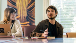 UNCG students Sophia Rosenberg and Ethan Divon talk during a meeting.