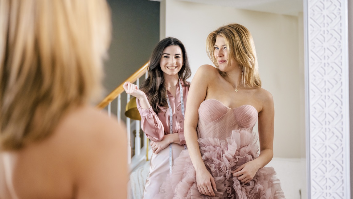 Cassidy Burel and client look at the final wedding dress together.