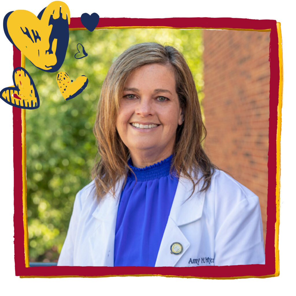 Woman in a white lab coat poses in front of a brick wall. Red frame and blue and gold heart graphics have been added to headshot. 