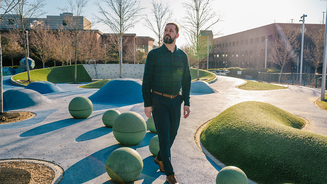 A man walks in a park.