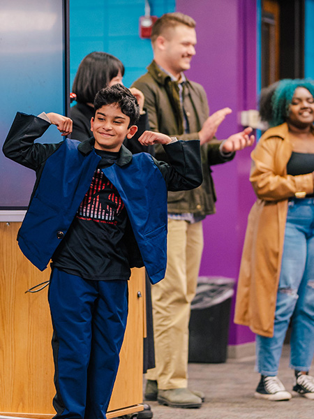 Oak View Elementary student shows off his new outfit designed by UNCG students.
