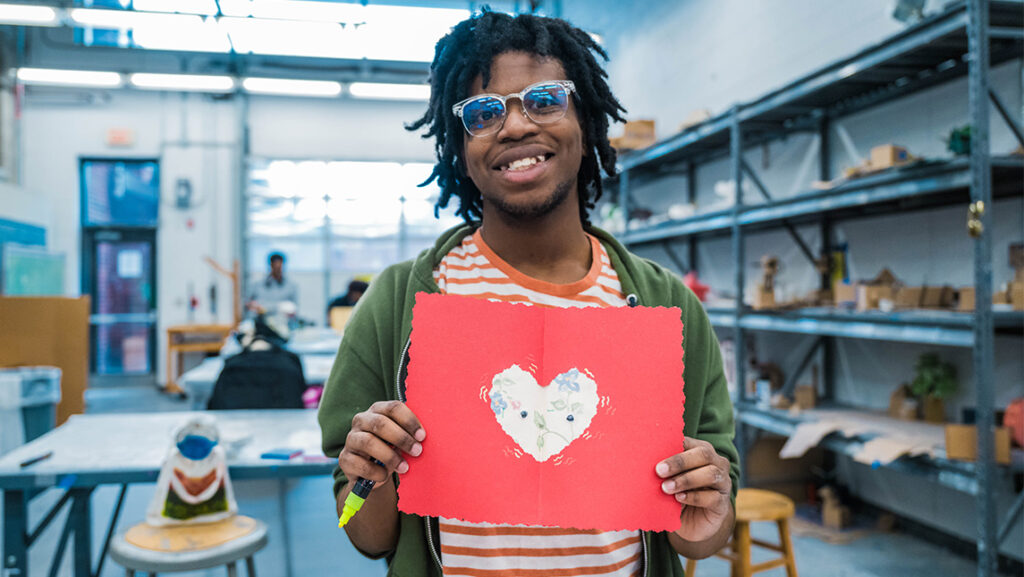 A UNCG student shows off a homemade valentine.