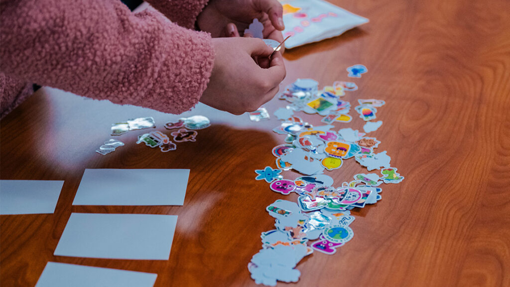 A UNCG student selects a sticker for a valentine.