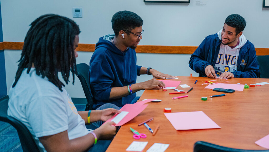 UNCG students make Valentines with the Letter Project.