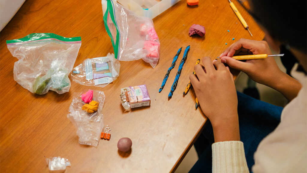 Twisting colored clay.