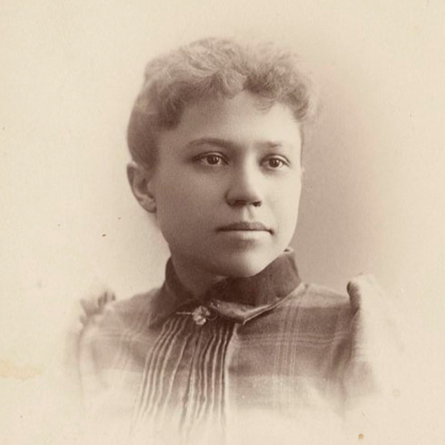 Sepia tone head shot photo of a woman from 1892.