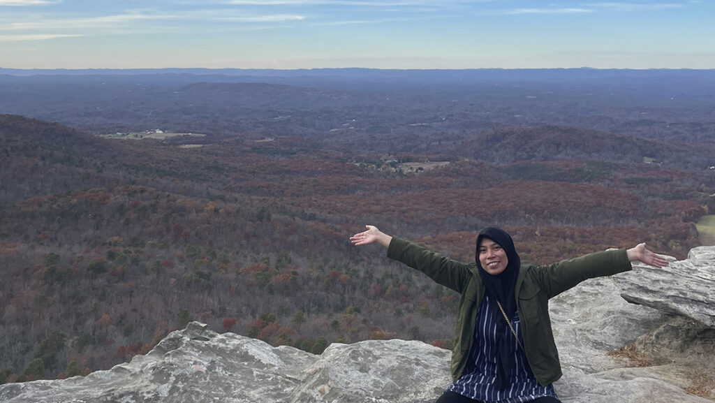 Desy Ratansari on a mountain vista