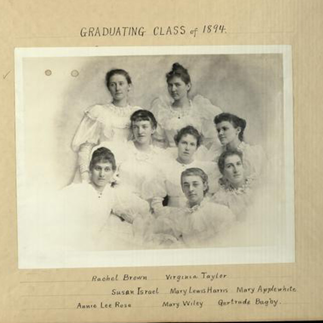 Old photo of 8 women from a scrapbook. Graduating class of 1894.