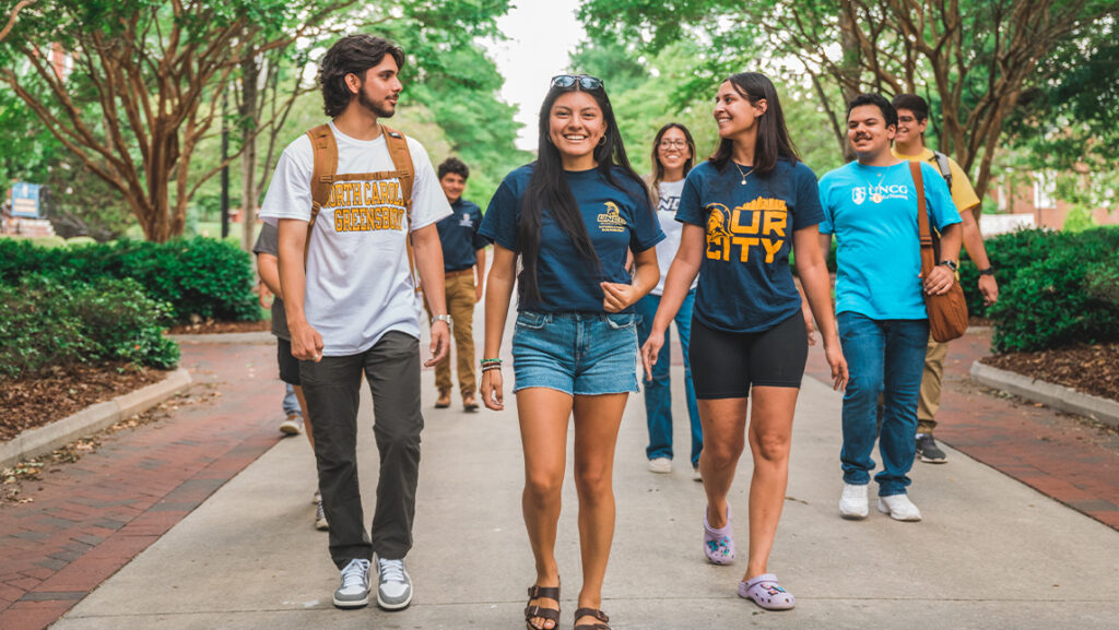 Students smiling and walking on campus