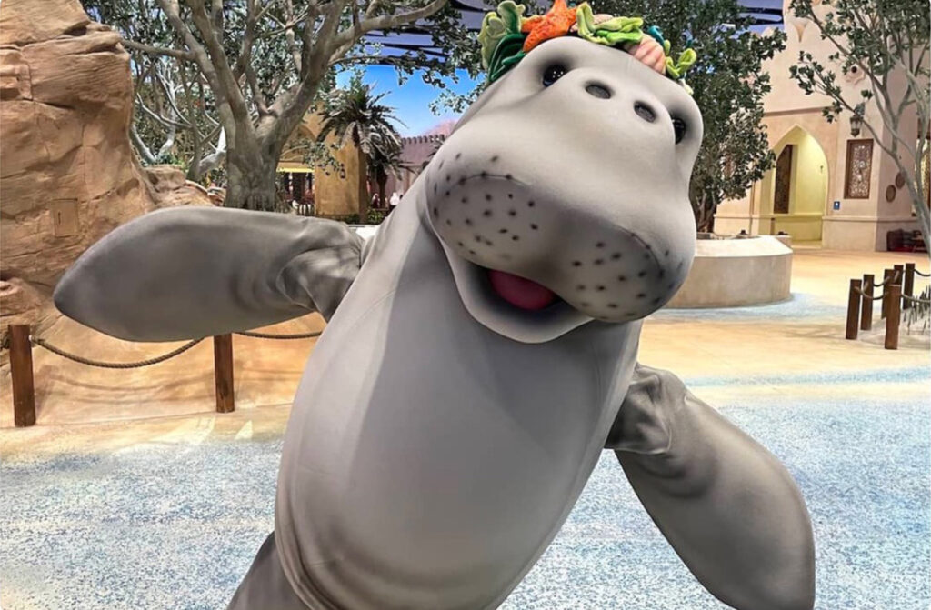 A SeaWorld actor dresses as a giant dugong.