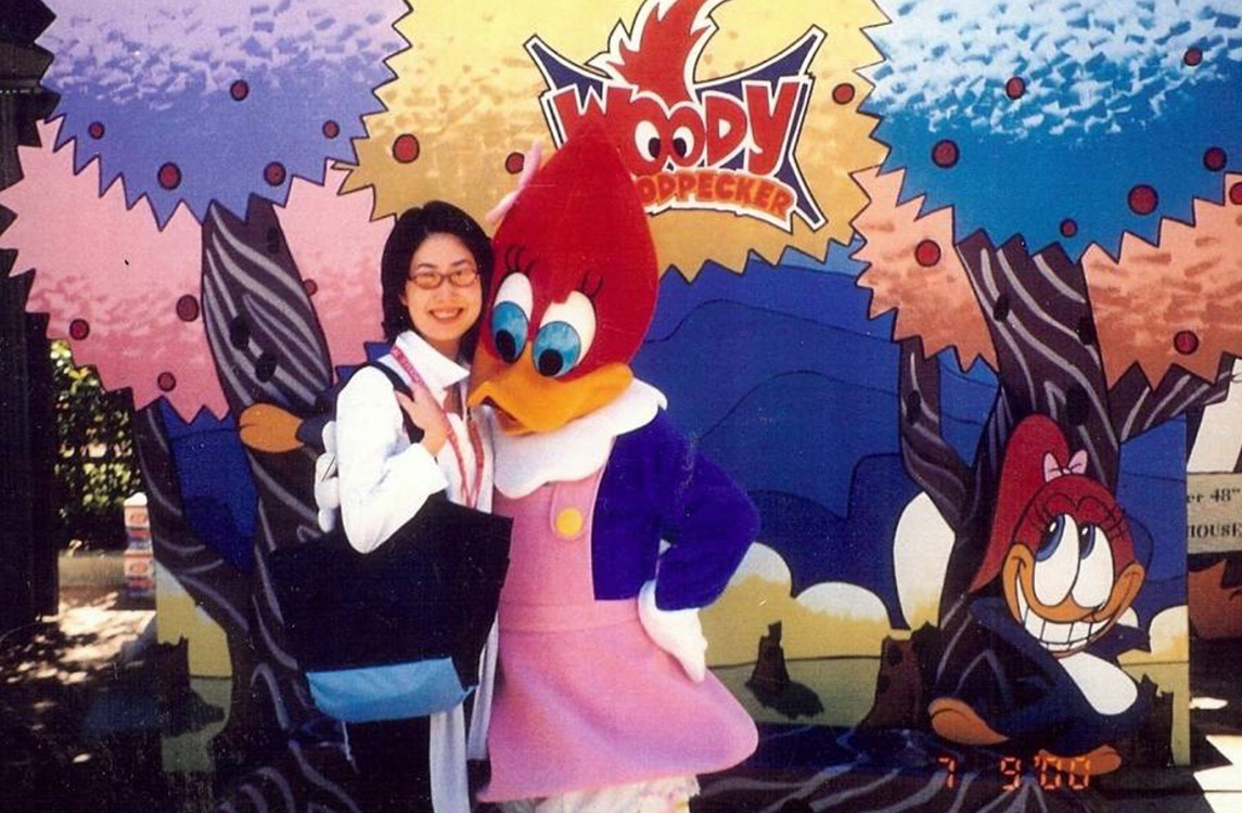 A theme park guest hugs Winnie from Woody the Woodpecker.